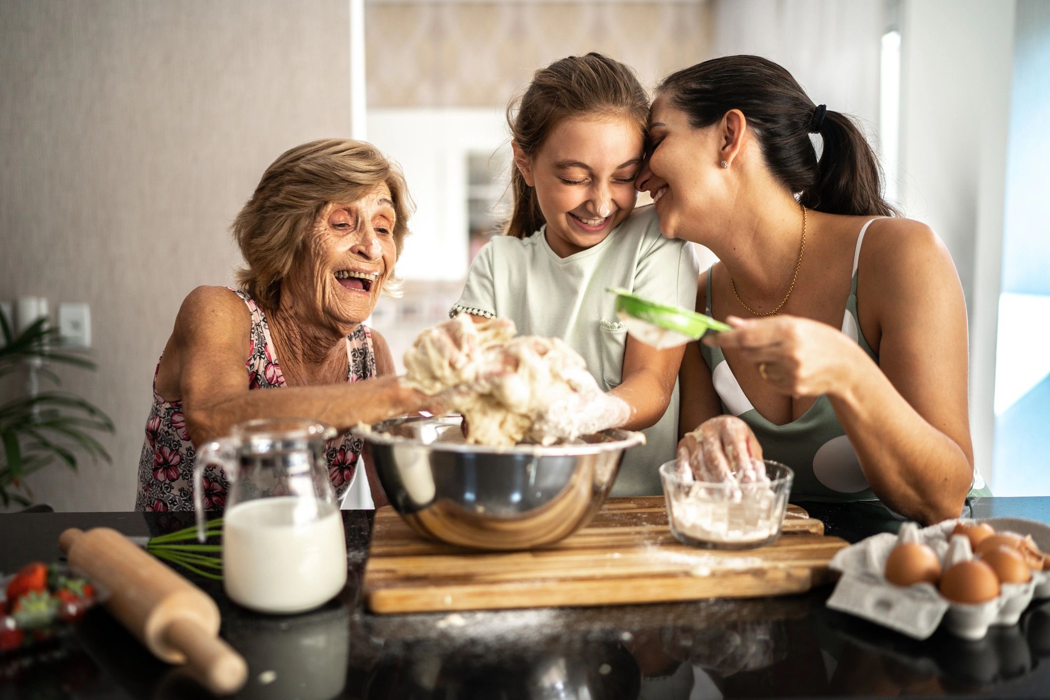 Family gathered together preparing food at home
